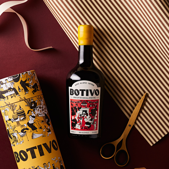 Botivo Wintery Botanical bottle and gift tube on wrapping paper with ribbon and scissors